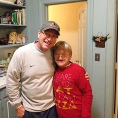 Alex in a cap with a friend in a red shirt