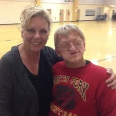 Alex and a friend in a gymnasium