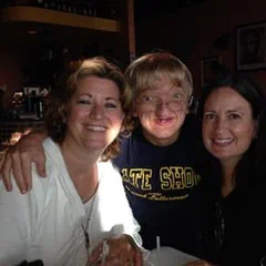 Three friends smiling indoors