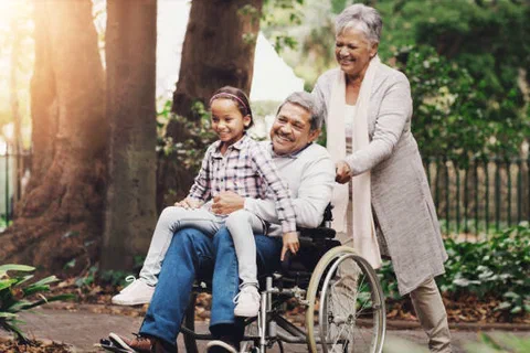 Grandparents and a child walking together in a park