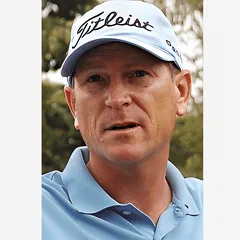 John Inman wearing a Titleist cap and blue polo shirt outdoors